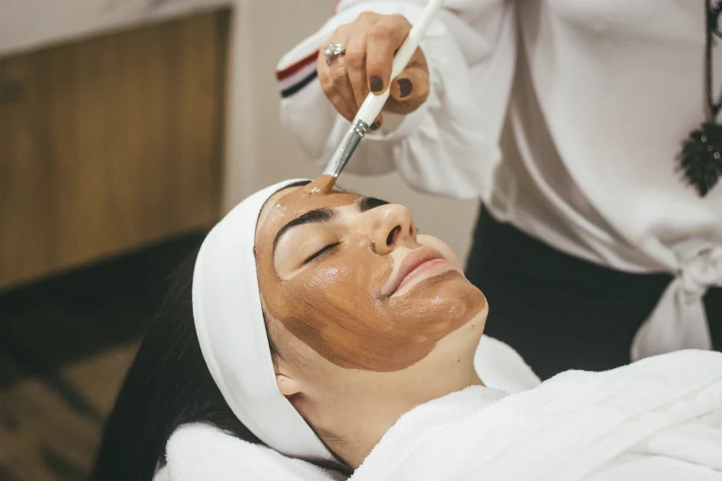 Client receiving a professional facial mask treatment at Juniper Reign Aesthetics and Wellness spa