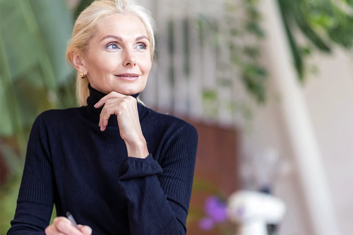 Woman in midlife reflecting during perimenopause and menopause hormone health discussion